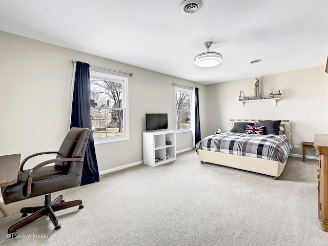 carpeted bedroom with visible vents, multiple windows, and baseboards