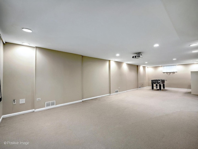 finished basement featuring recessed lighting, visible vents, and carpet floors