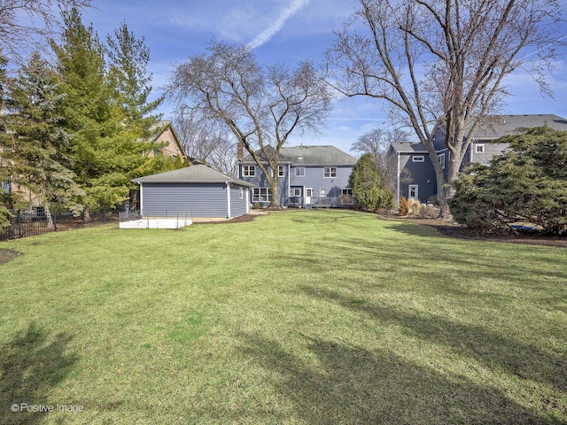 view of yard featuring an outdoor structure and fence