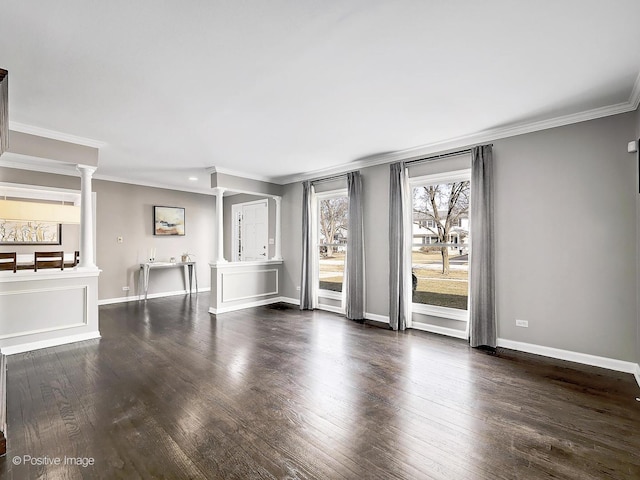 unfurnished living room featuring ornate columns, baseboards, wood finished floors, and ornamental molding