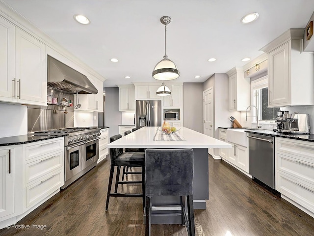 kitchen featuring white cabinets, appliances with stainless steel finishes, dark wood-type flooring, and exhaust hood