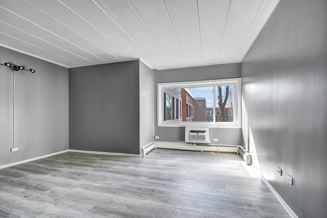 bonus room with baseboards, an AC wall unit, and wood finished floors