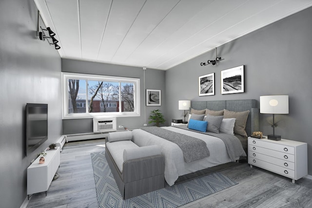 bedroom featuring an AC wall unit and wood finished floors