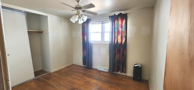 unfurnished bedroom featuring ceiling fan, visible vents, a closet, and wood finished floors