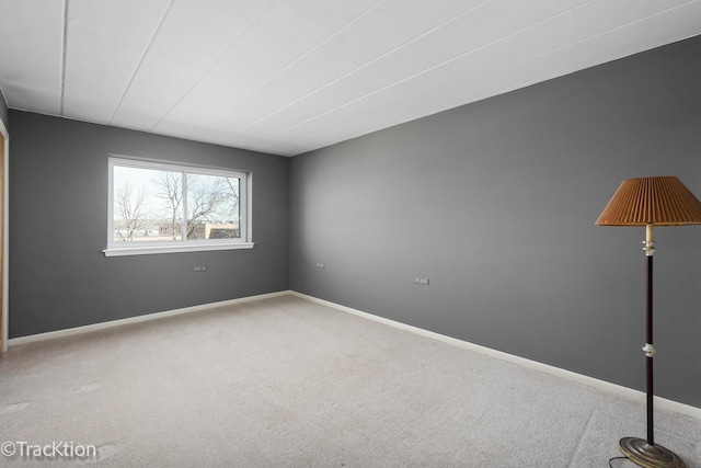 spare room with carpet and baseboards