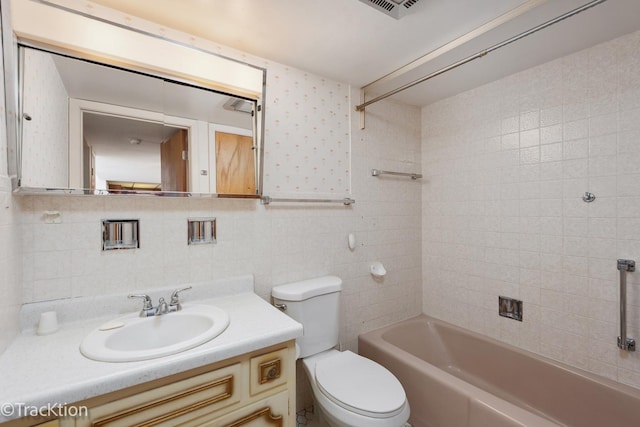 full bathroom featuring tile walls, toilet, shower / bath combination, decorative backsplash, and vanity