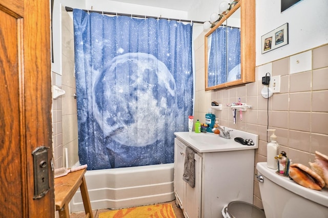 full bathroom with toilet, backsplash, tile walls, shower / tub combo, and vanity