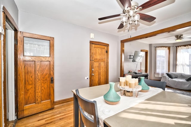 dining space featuring light wood-style flooring and a ceiling fan