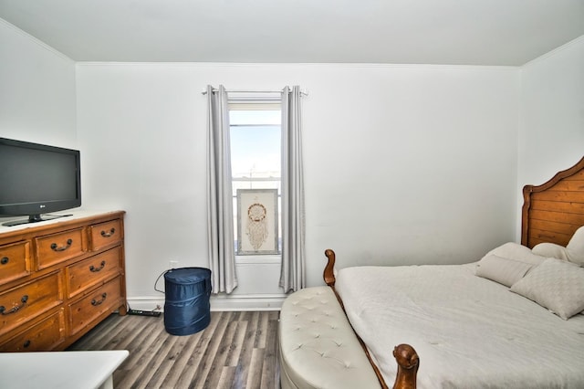 bedroom with crown molding and dark wood-type flooring