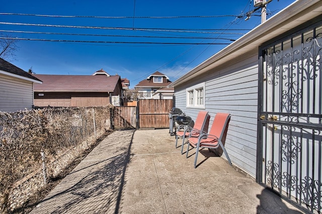 view of patio with a gate and fence