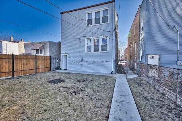 rear view of property with a fenced backyard