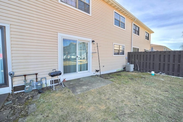 back of house with central AC and fence