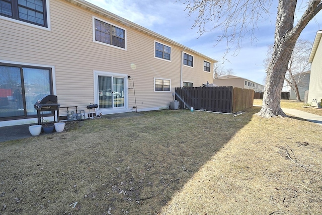 back of property with central air condition unit and fence