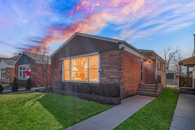 view of front of property with stone siding and a front yard