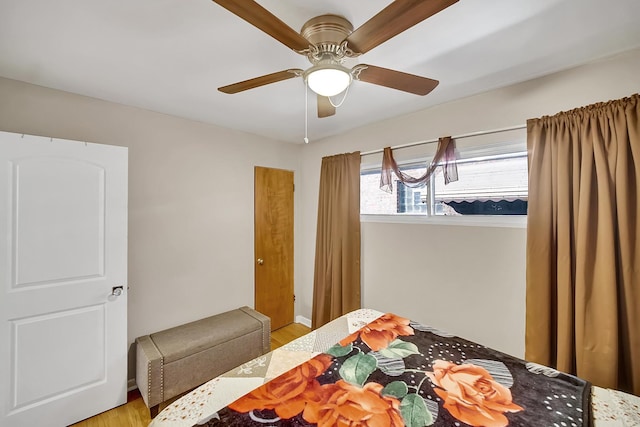 bedroom featuring a ceiling fan and wood finished floors