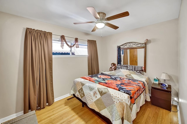 bedroom with wood finished floors, baseboards, and ceiling fan