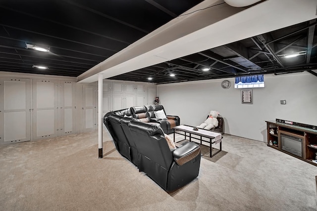 home theater room featuring light colored carpet