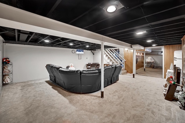 carpeted living area with stairs