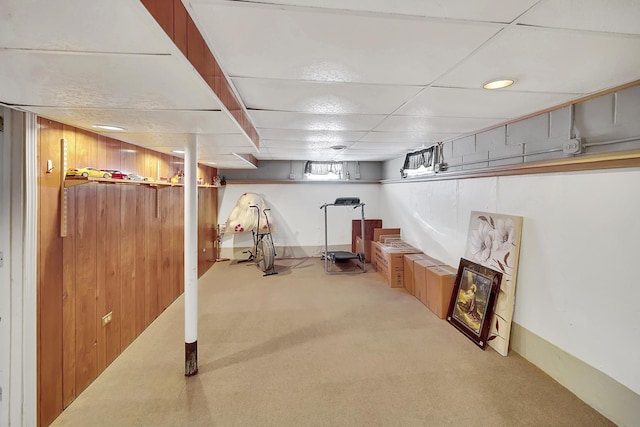 workout area with carpet flooring and a drop ceiling