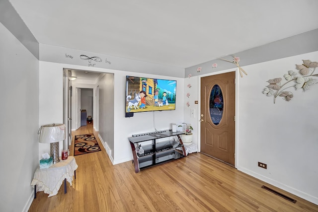 foyer featuring visible vents, baseboards, and light wood finished floors