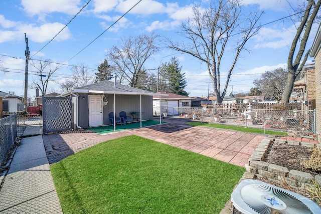 view of yard with an outbuilding, central air condition unit, a patio area, and a fenced backyard