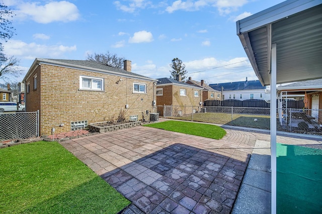 back of property featuring brick siding, a chimney, and fence private yard