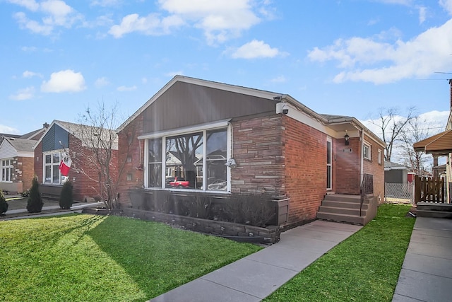 view of front facade with stone siding and a front yard