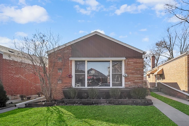 view of front of house with stone siding and a front yard