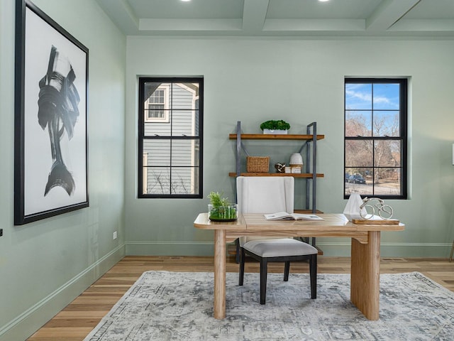 office featuring beamed ceiling, baseboards, coffered ceiling, and light wood finished floors