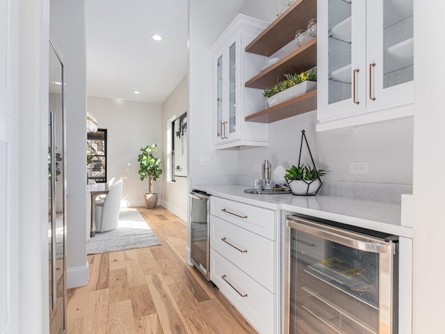 bar featuring beverage cooler, a dry bar, recessed lighting, and light wood finished floors