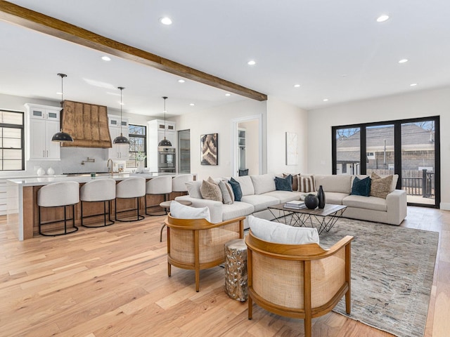 living room featuring beam ceiling, recessed lighting, and light wood finished floors