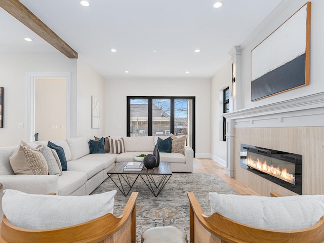 living room with a glass covered fireplace, beamed ceiling, recessed lighting, and baseboards