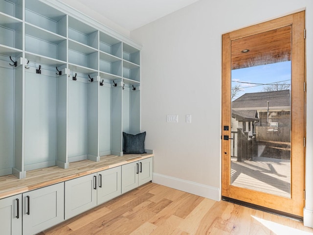 mudroom with light wood-style floors and baseboards