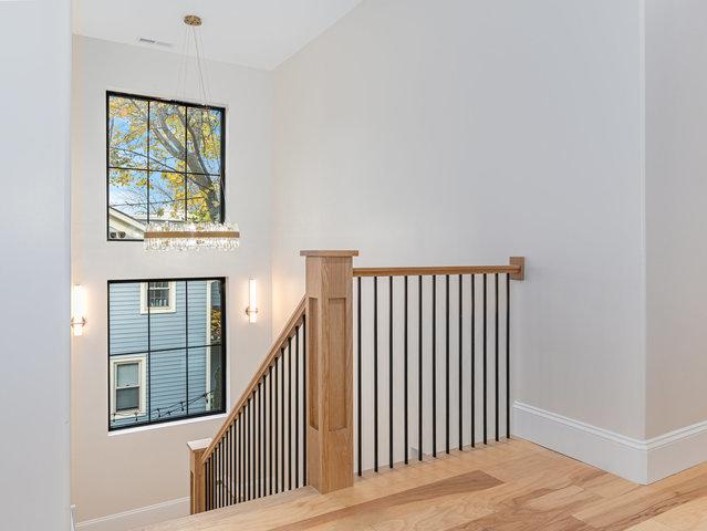 stairway with baseboards and wood finished floors