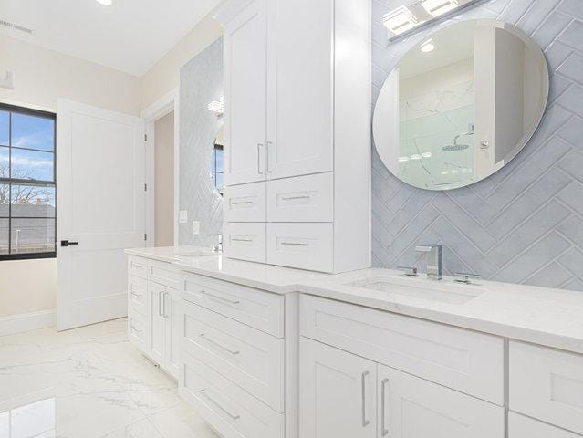 bathroom featuring visible vents, marble finish floor, a walk in shower, decorative backsplash, and vanity