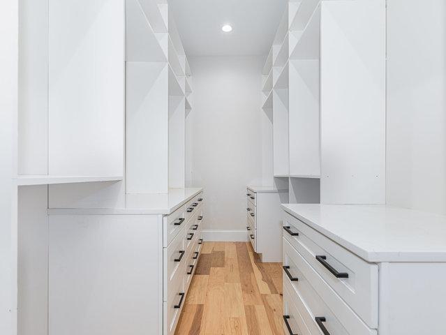 walk in closet featuring light wood-style flooring