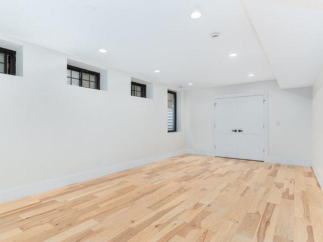 basement featuring recessed lighting, wood finished floors, and baseboards