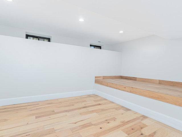 interior space featuring recessed lighting, wood finished floors, and baseboards