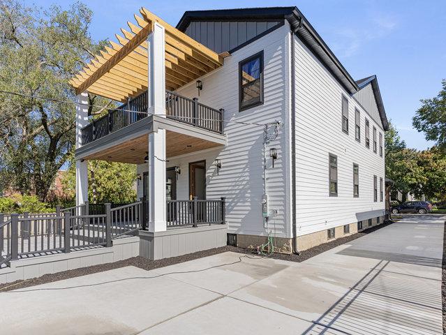 view of property exterior with a balcony, covered porch, and board and batten siding