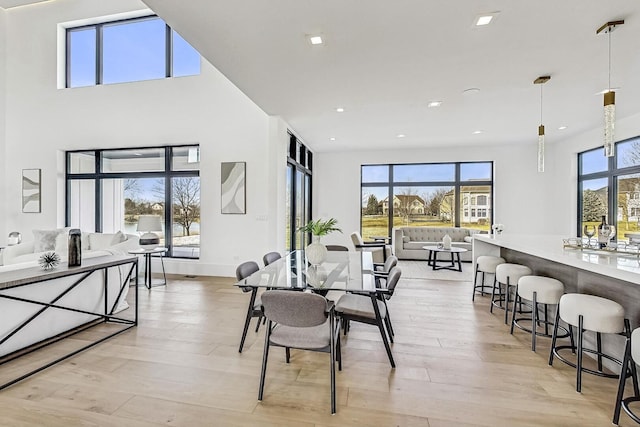 dining space with light wood finished floors, plenty of natural light, and recessed lighting