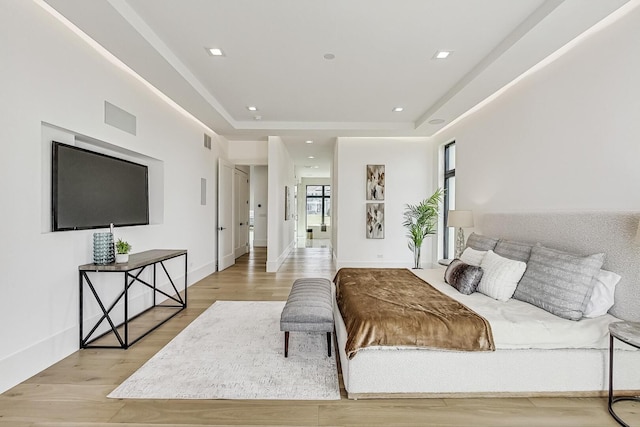 bedroom featuring a tray ceiling, recessed lighting, light wood-style floors, and visible vents