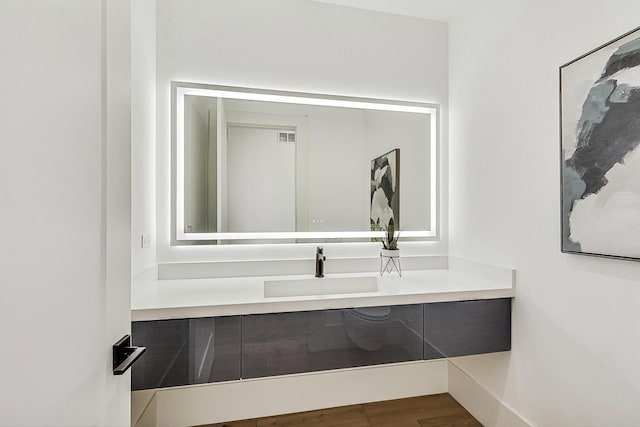 bathroom featuring vanity and wood finished floors