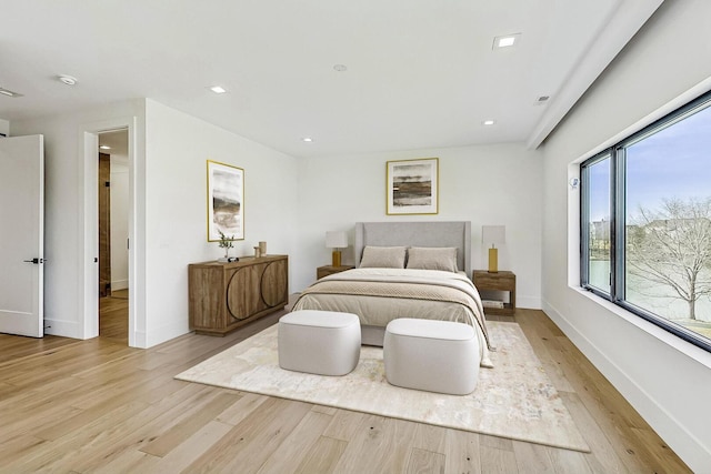 bedroom with recessed lighting, baseboards, and light wood-style floors