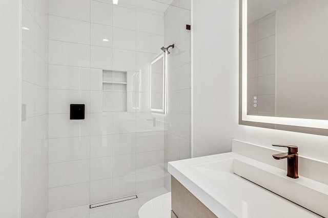 bathroom featuring toilet, a stall shower, and vanity