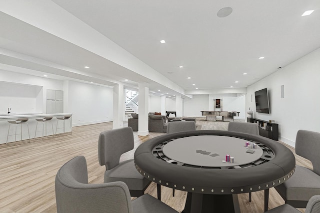 interior space featuring recessed lighting, light wood-style flooring, stairs, and baseboards