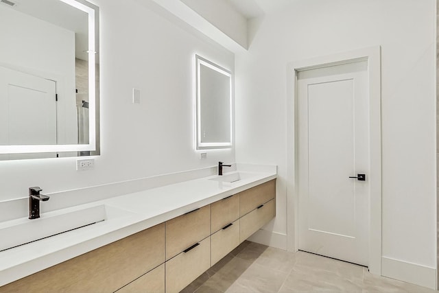 bathroom with double vanity, visible vents, and a sink