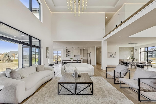 living room featuring light wood finished floors and a chandelier