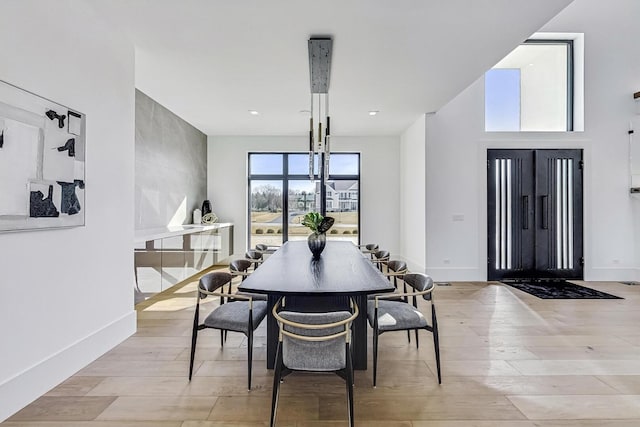 dining room with baseboards and light wood-type flooring