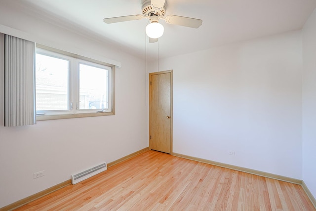 spare room featuring visible vents, baseboards, light wood-style flooring, and a ceiling fan