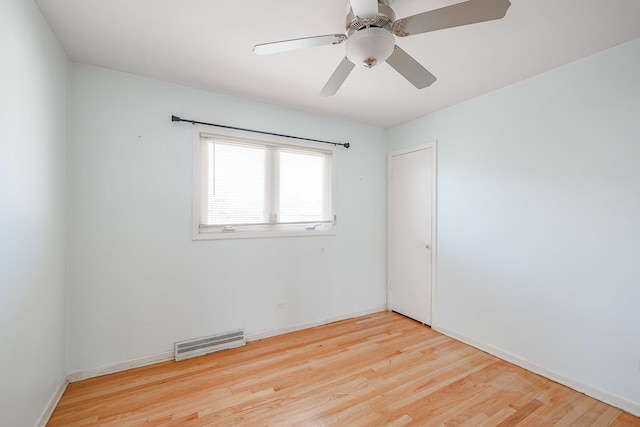 unfurnished room featuring visible vents, baseboards, wood finished floors, and a ceiling fan